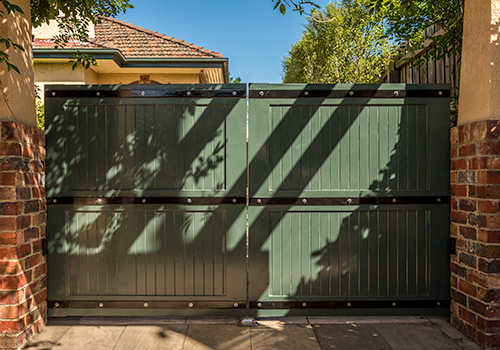 Wooden feature driveway gates with metal decoration